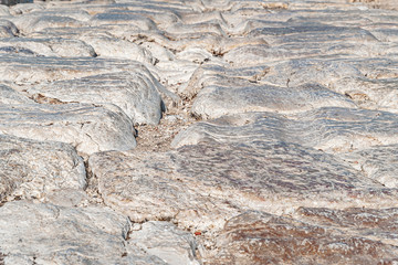 abstract background of an ancient paved stone road close up