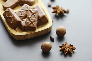 Chocolate bars on a black background in backlight. Chocolate with filling. Sweet sweets for snack and tea.