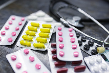 Medical concept. Oral medication. Capsule, tablet, droplet in a strip for dispensing. Colored oral dosage form in stripes.