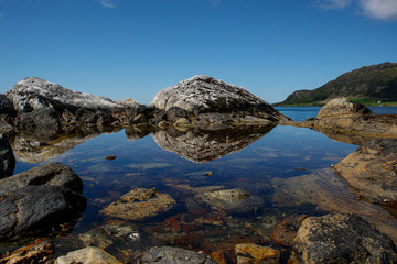 stone reflection in the water of the seaside