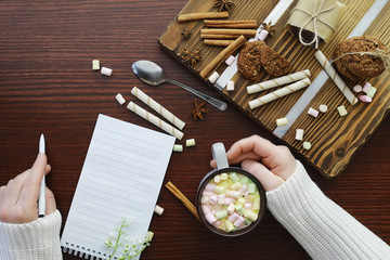 Winter breakfast. A cup of hot chocolate with marshmallows and freshly baked cookies. Gingerbread cookie and coffee.