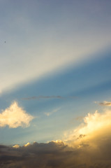 Landscape with dramatic light - beautiful golden sunset with saturated sky and clouds.