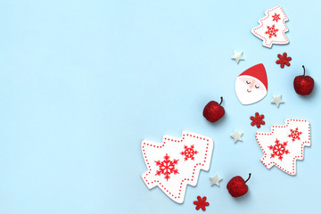 New Year and Christmas composition. Frame frome red and white christmas toys on blue background. Top view, flat lay, copy space