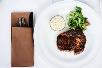 steak with sauce and rucola salad