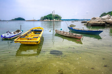 Naklejka na ściany i meble A wooden boats used by fishermen by the beach. Bintan, Indonesia.