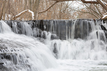 Small river cascade step on a winter 
