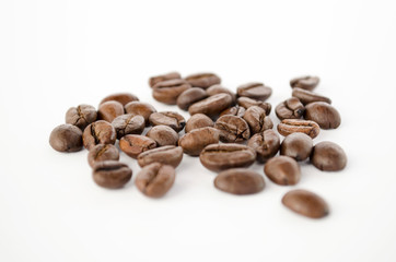Coffee beans isolated on the white background. Grains of coffee close-up. Selective focus