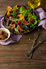 Healthy salad with avocado on rustic table