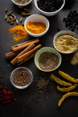 Different spices in small bowls top view
