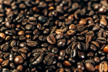a lot of coffee beans on a wooden background. background and space for text