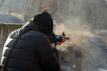 Man shooting at a target. Unformal shooting range near Kiev. 