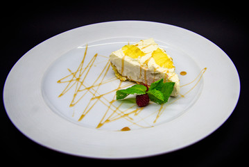 Lemon cheesecake on black background