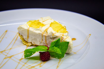 Lemon cheesecake on black background