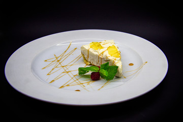 Lemon cheesecake on black background