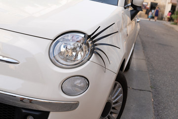 car with plastic long eyelashes on the headlight