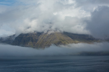 Clouds surrounding hills and mountains in the Faroe Islands