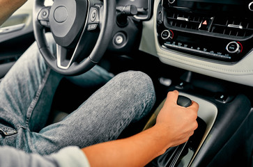 Car Driving Concept. Driver Shifting To Drive Mode. Hand on Transmission Stick Closeup