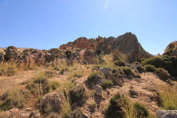 Volcanic rocky red cliffs in Milos, Greece