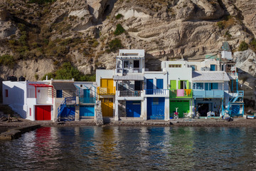 Fototapeta na wymiar Colorful doors and boats in the fishing village of Klima in Milos, Greece