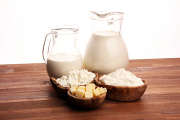Different  healthy dairy products on rustic background with milk, cheese, butter and cottage