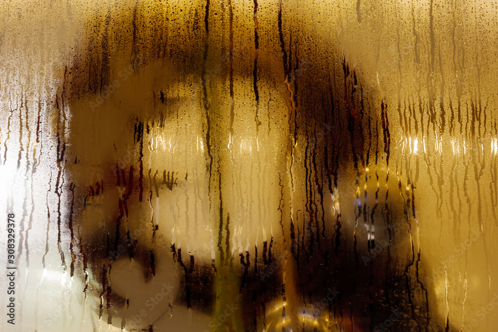 Wall mural close up and macro view of raining water drop on glass window and blur background with circle round 