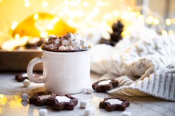 Comforting Christmas food, mug of hot cocoa with marshmallow and cookies with cozy lights