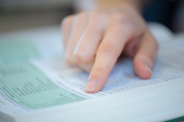 pointing at the specific word on the book