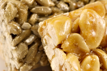Fototapeta na wymiar sugar glazed kozinak, sunflower seeds and peanuts in sugar glaze, Oriental sweets close-up macro, brittles