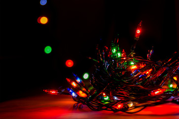 lights from a Christmas garland in a dark room, burning light bulbs, winter Christmas mood