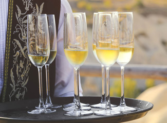 Glasses of champagne on a tray, served on a wedding reception