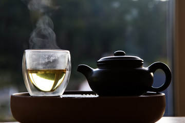 Teapot with a cup of tea