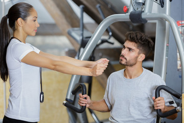 Fototapeta premium man and woman fitness during workout in gym indoors