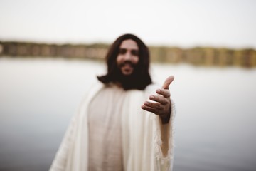 Jesus Christ lending a helping hand with a blurred background