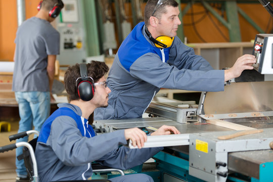 Disabled Worker In Wheelchair In Factory