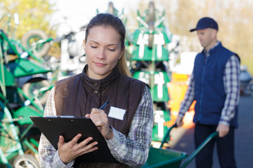 female engineer taking notes outside a metallurgy factory
