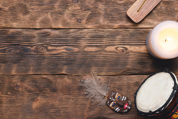 Shaman accessories on wooden table background.