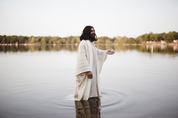 Jesus Christ walking in the water with his hand up