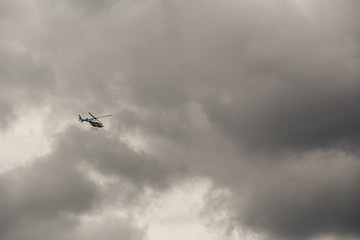 Helicopter in the clouds. Quickly climbs