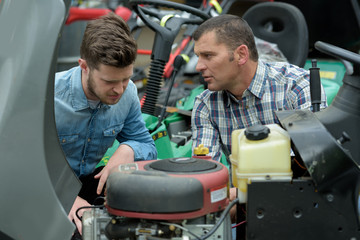 portrait of two mechanics repairing modern equipment