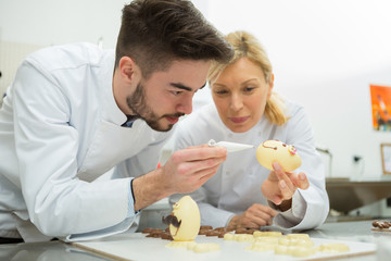 portrait of people working on easter eggs