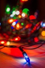 lights from a Christmas garland in a dark room, burning light bulbs, winter Christmas mood