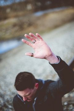 Male with his hand up while praying