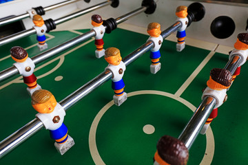 dolls of a retro foosball table to play table football