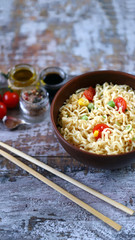 Chinese noodle bowl with spices. Food sticks. Selective focus.
