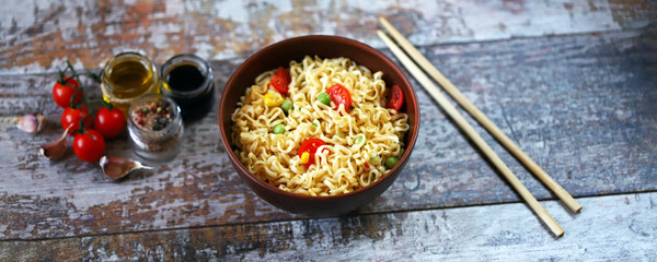 Chinese noodle bowl with spices. Food sticks. Selective focus.