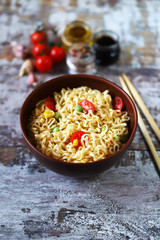 Chinese noodle bowl with spices. Food sticks. Selective focus.