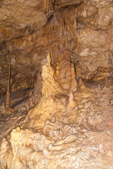 underground cave with many stalactites and stalagmites of different shapes, speleology and geology