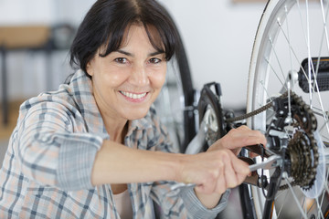 Fototapeta na wymiar woman mature taking care of her bike
