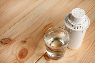filter for cleaning tap water for drinking and a glass of filtered clean water