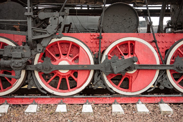 Naklejka premium wheels of an ancient locomotive close-up, retro vehicle